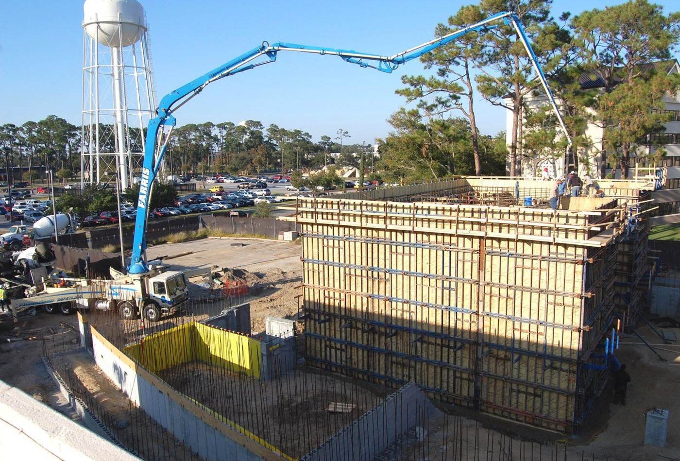 Concrete pump truck and wall formwork on a commercial job site